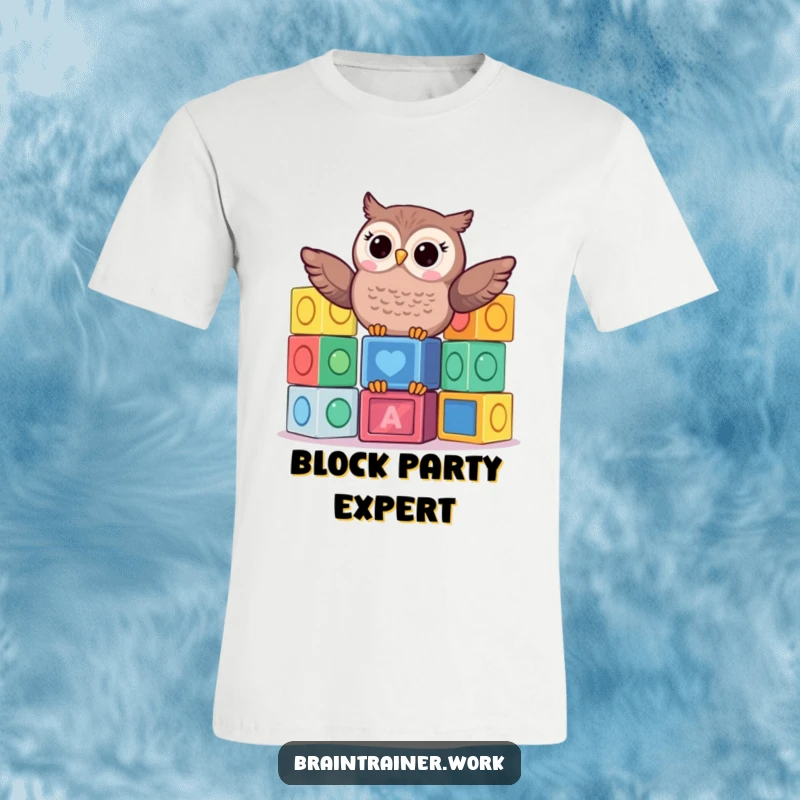 Funny kawaii owl humorously balancing a stack of colorful learning blocks on its head, printed on a t-shirt.